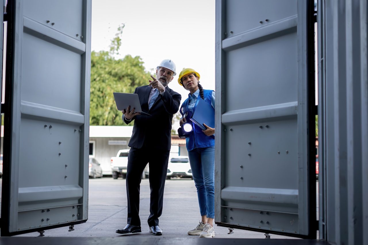 business people looking in portable storage container